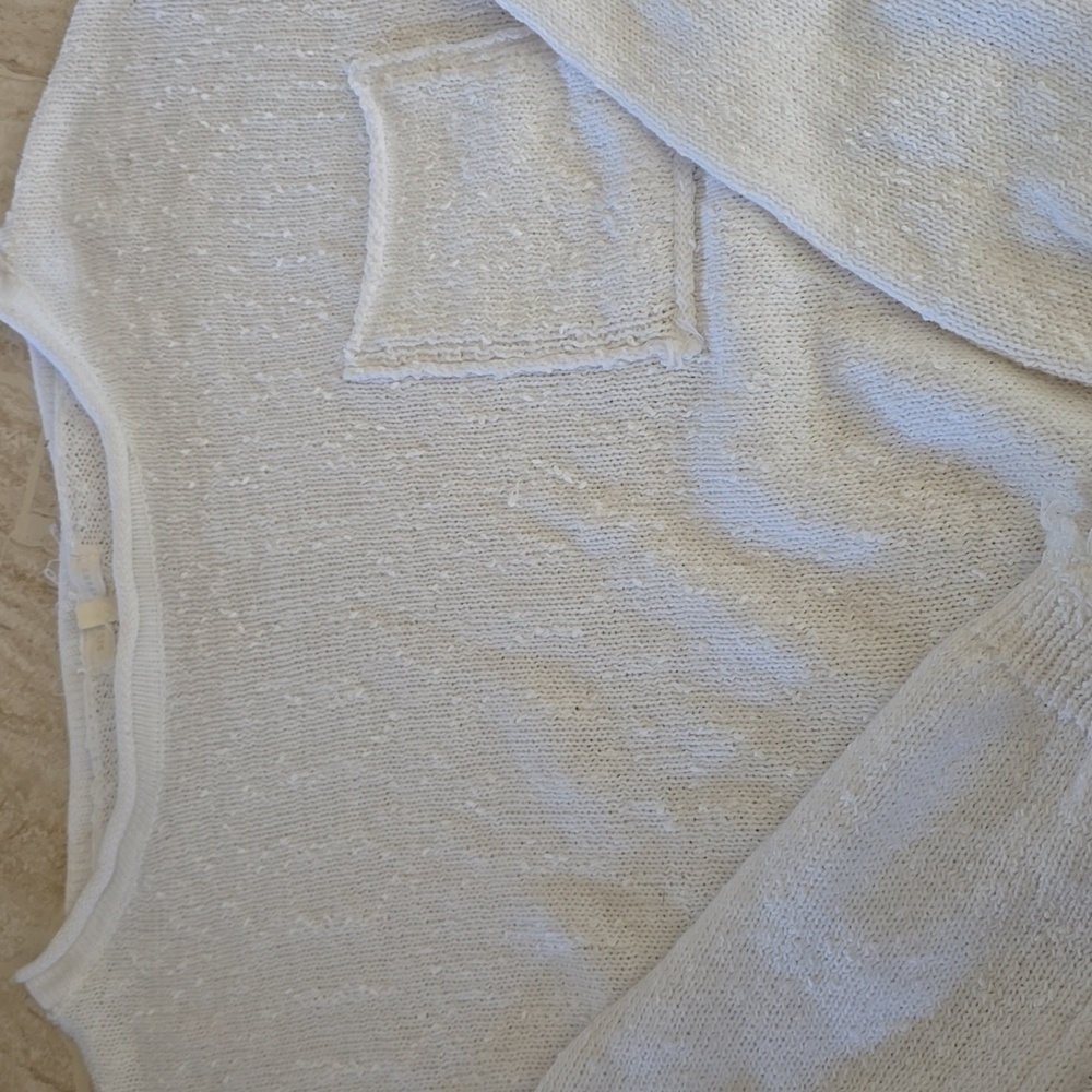 Cotton sweater with high/low waist...distressed edge on cuffs and hem.
